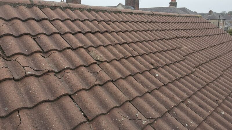 Storm damaged tiled roof with cracked tiles on a UK house